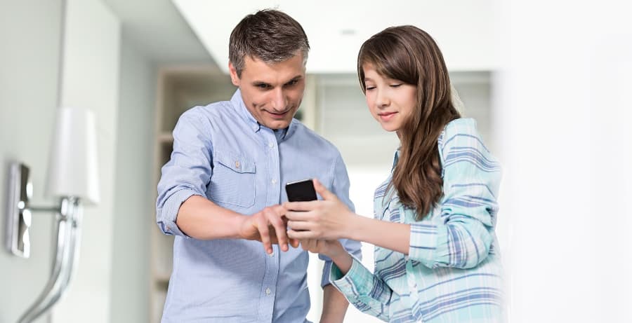 Father and daughter using an app on a smartphone